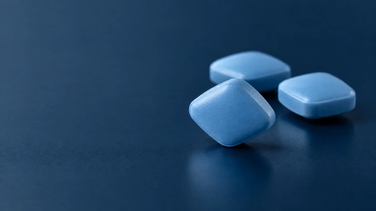 Blue rounded-diamond tablets illustrating sildenafil